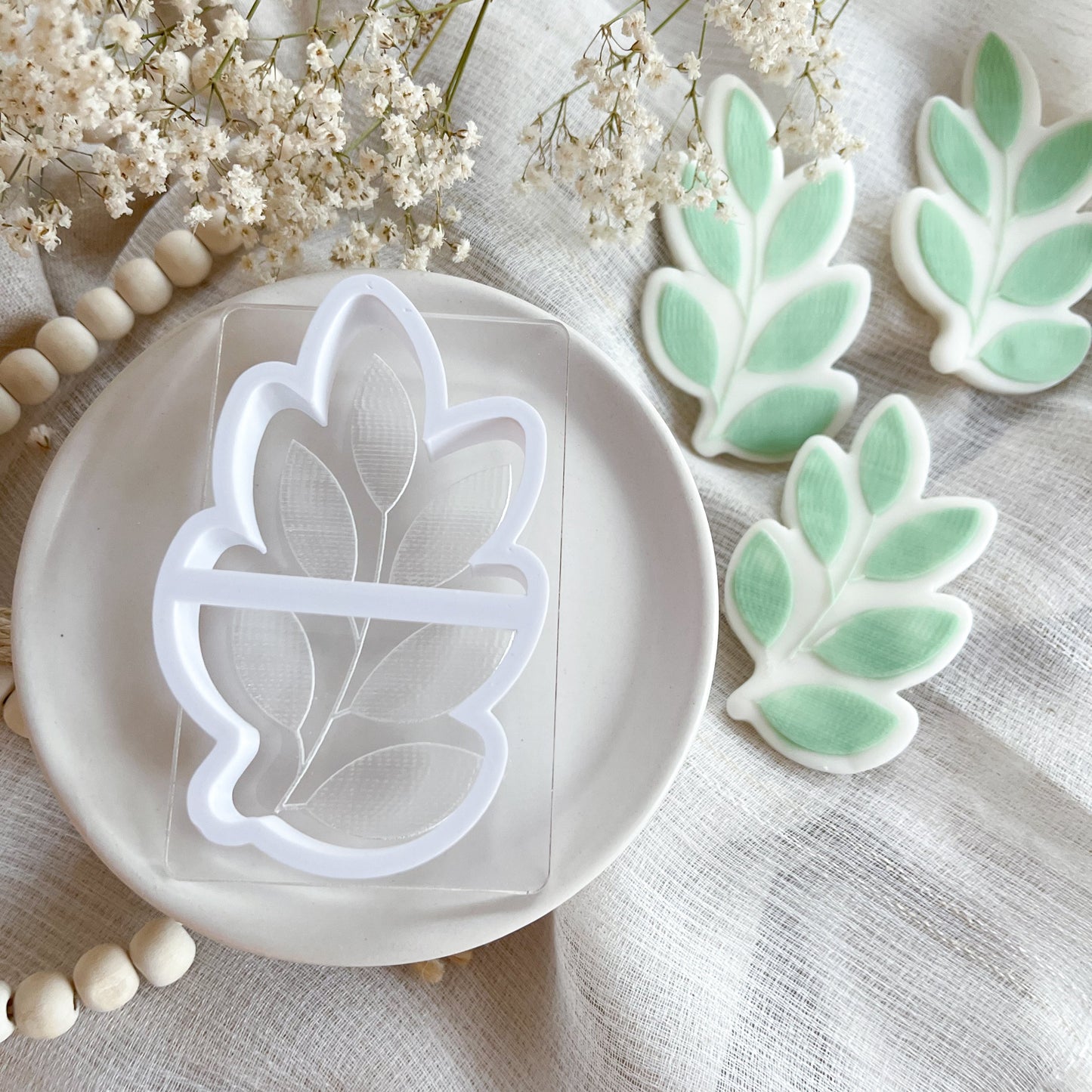 Leaf cookie cutter and embosser with rustic botanical texture for fall baking and earthy cookie designs.