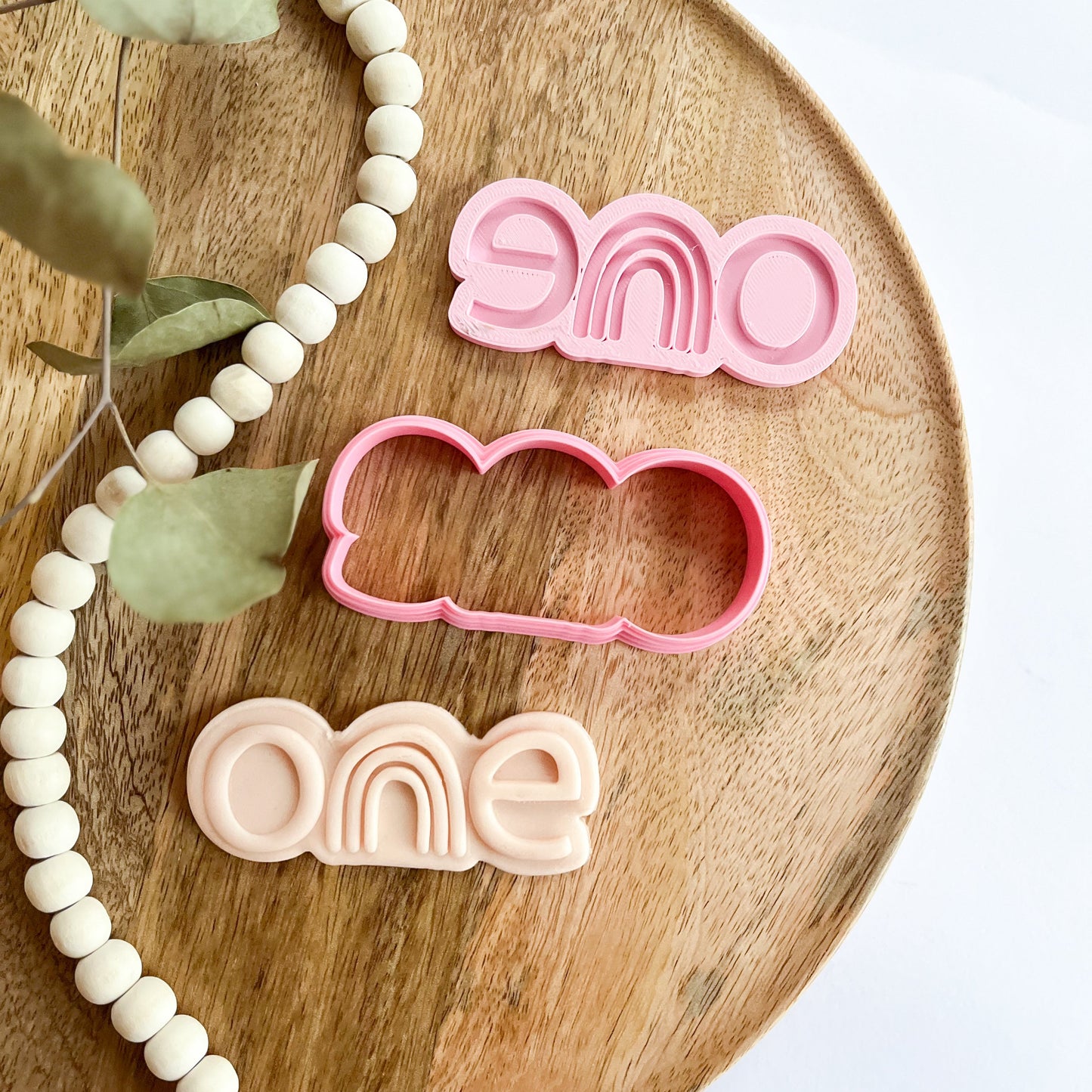 Rainbow “one” cookie cutter and embosser for first birthday celebration treats or baby milestone party favors.