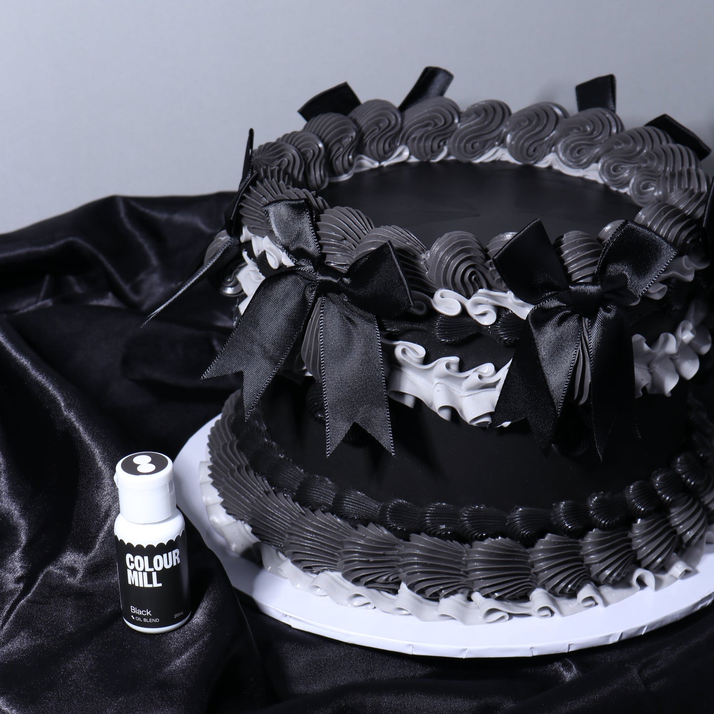 Black and white cake with decorative elements on a dark surface