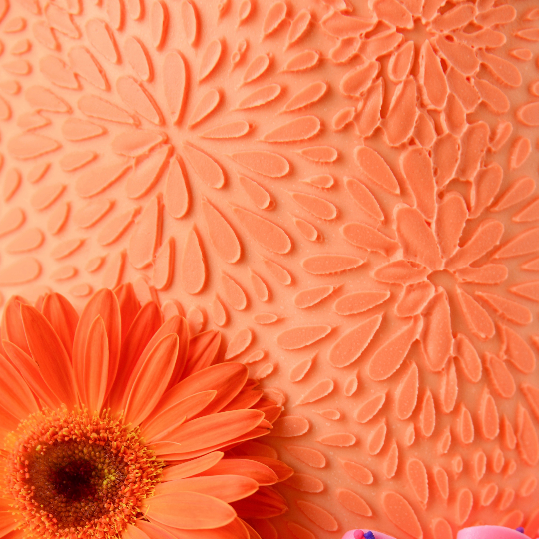 Close-up of an orange flower with a textured orange background