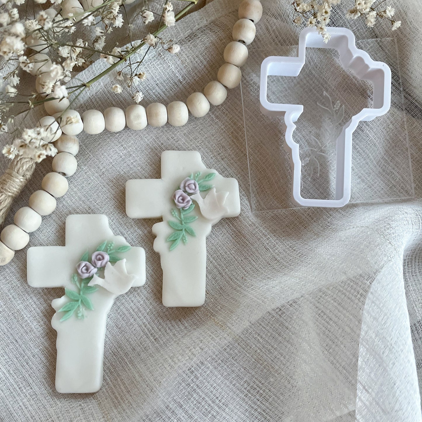 Elegant cross cookie cutter with leaf detail embosser for Easter, confirmations, and religious celebrations.