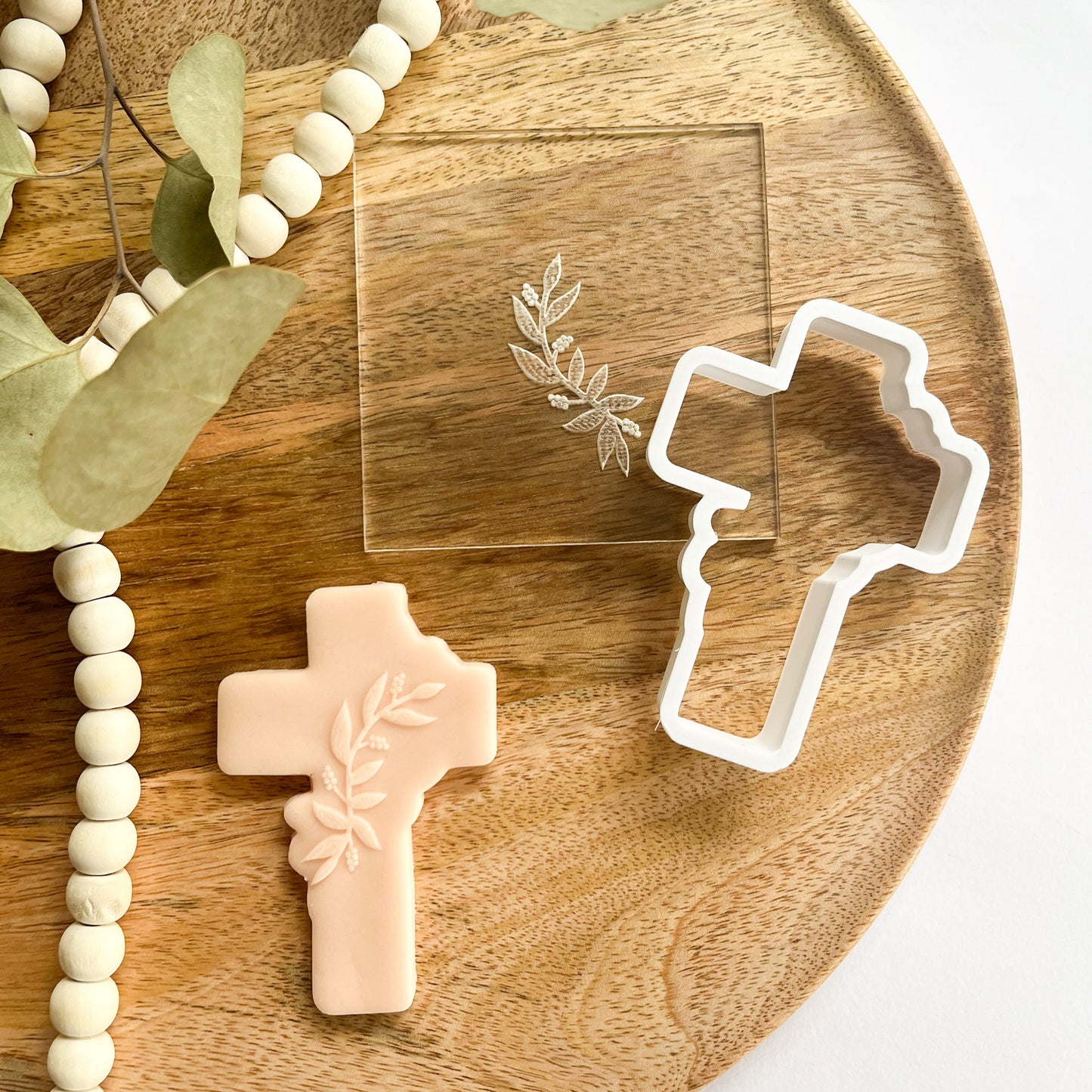 Elegant cross cookie cutter with leaf detail embosser for Easter, confirmations, and religious celebrations.