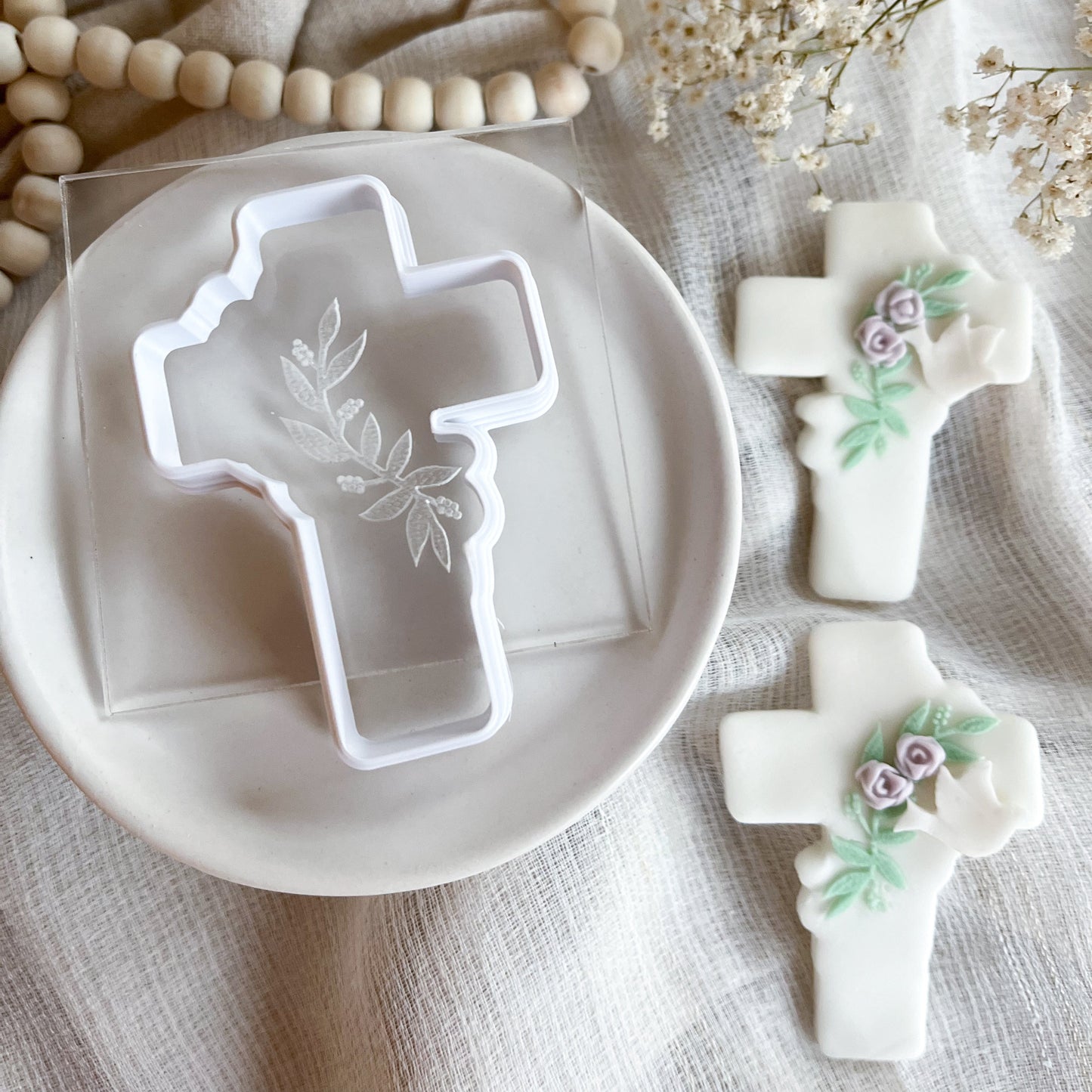Elegant cross cookie cutter with leaf detail embosser for Easter, confirmations, and religious celebrations.