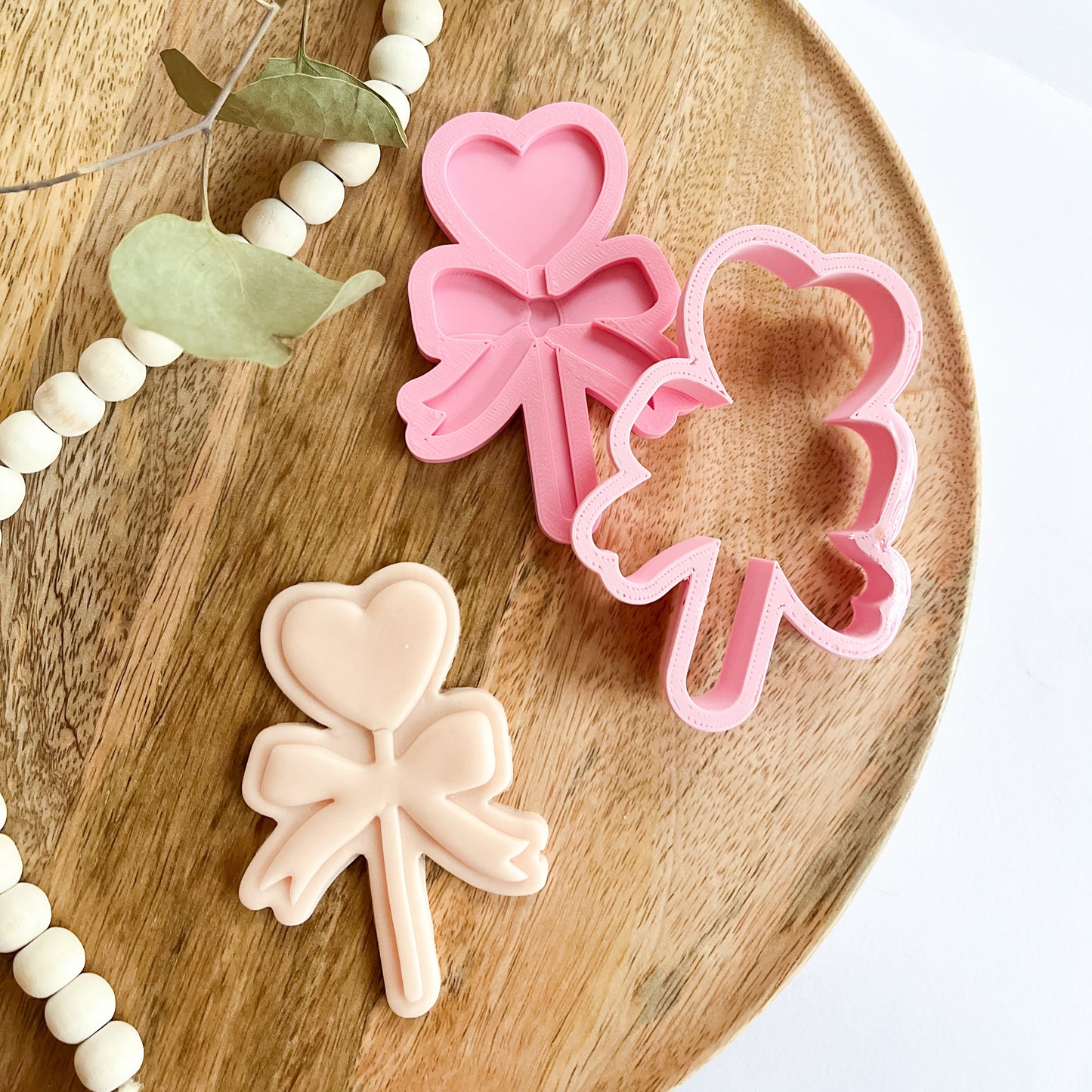 Heart-shaped cookie cutter on a stick with bow detail, perfect for cute cookies for parties, Valentine’s Day, or birthdays.