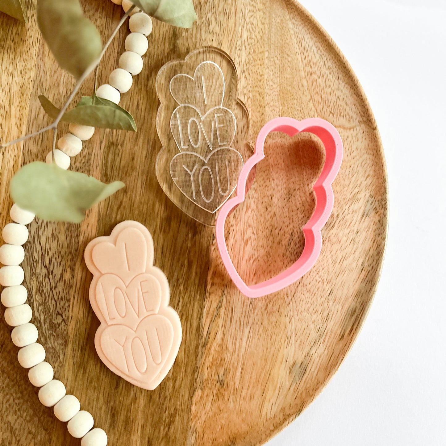 Heart stack cookie cutter with "I LOVE YOU" embossed text, ideal for romantic baking or Valentine's Day treats.