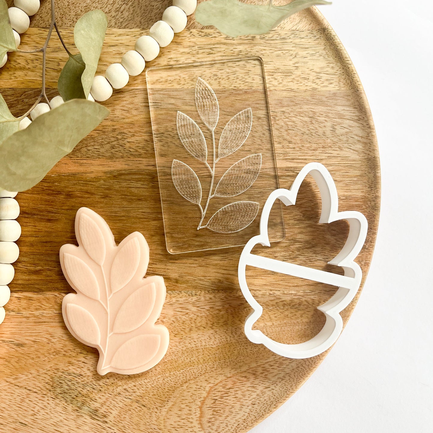 Leaf cookie cutter and embosser with rustic botanical texture for fall baking and earthy cookie designs.