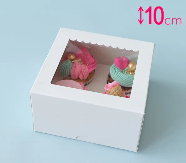 White cake box with a clear window displaying small cakes, on a light blue background.