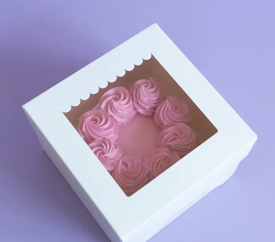 Pink heart-shaped soap in a white box on a purple background