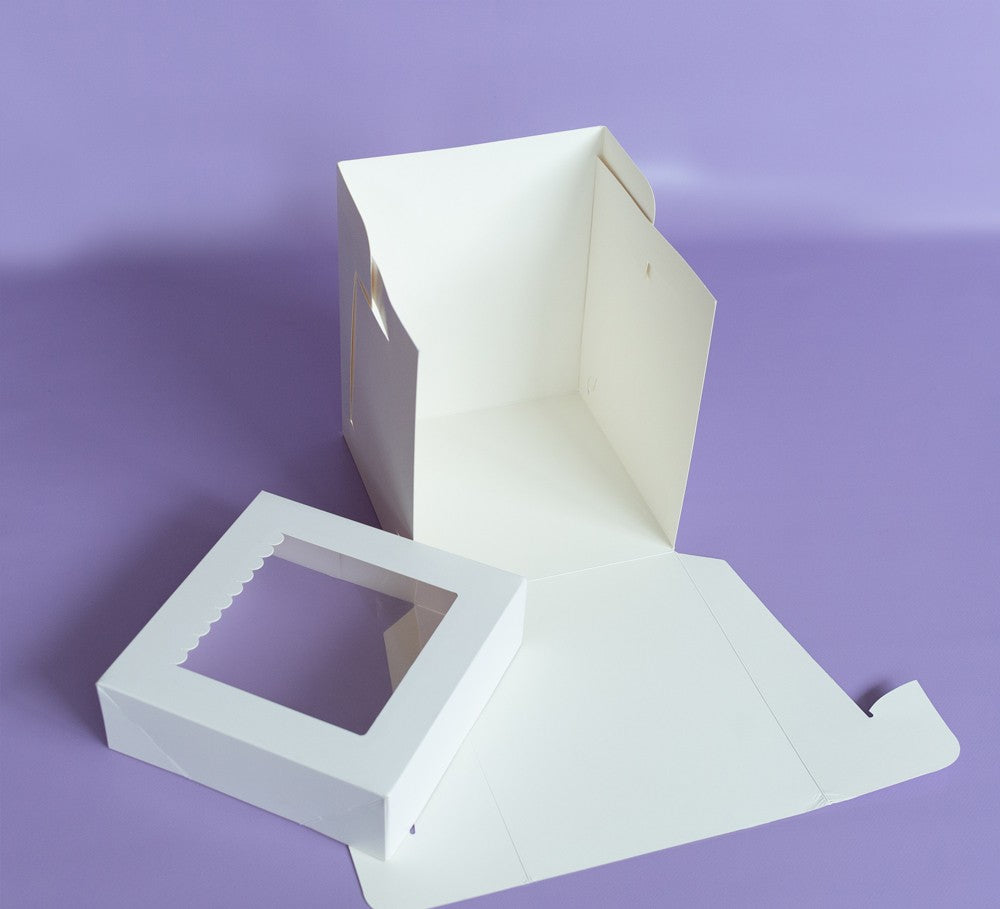 White cardboard box with a cutout section on a purple background