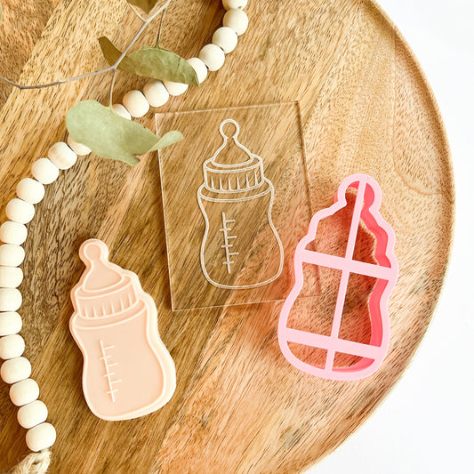 Baby bottle cookie cutter and embosser, ideal for baby showers, fondant cookies, and newborn baking.