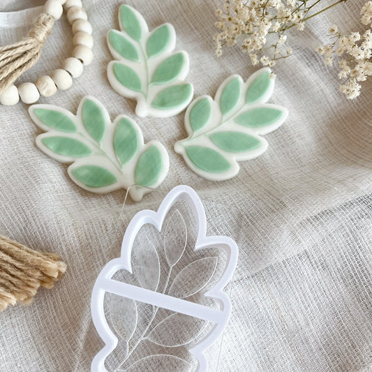 Leaf cookie cutter and embosser with rustic botanical texture for fall baking and earthy cookie designs.