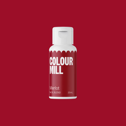 Bottle of Colour Mill Merlot oil blend on a red background