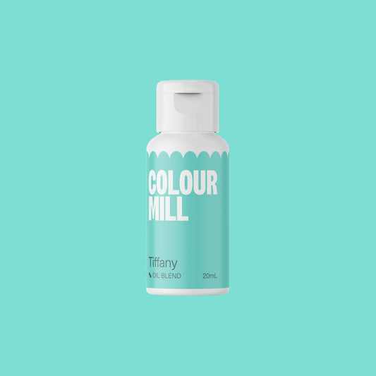 Bottle of Colour Mill oil blend on a teal background
