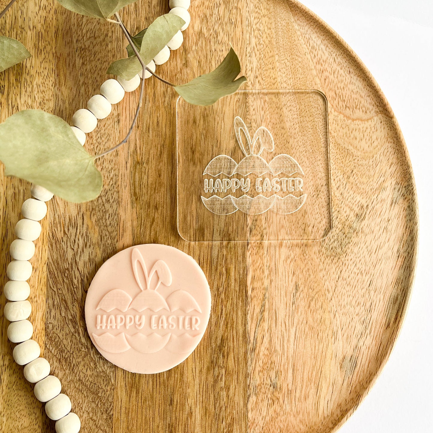 Cookie embosser with Happy Easter text and bunny ears over Easter eggs, perfect for spring baking and festive cookie decorating.