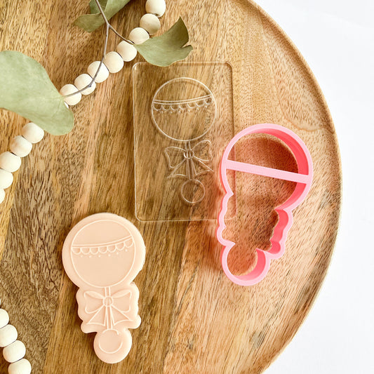 Baby rattle cookie cutter and acrylic stamp set for baby showers and gender reveal party cookies. Includes embosser for fondant or dough.