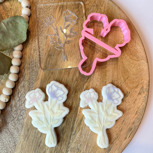 Leaf-shaped flower cookie cutter and embosser with detailed stem, perfect for spring cookie decorating or clay crafting.