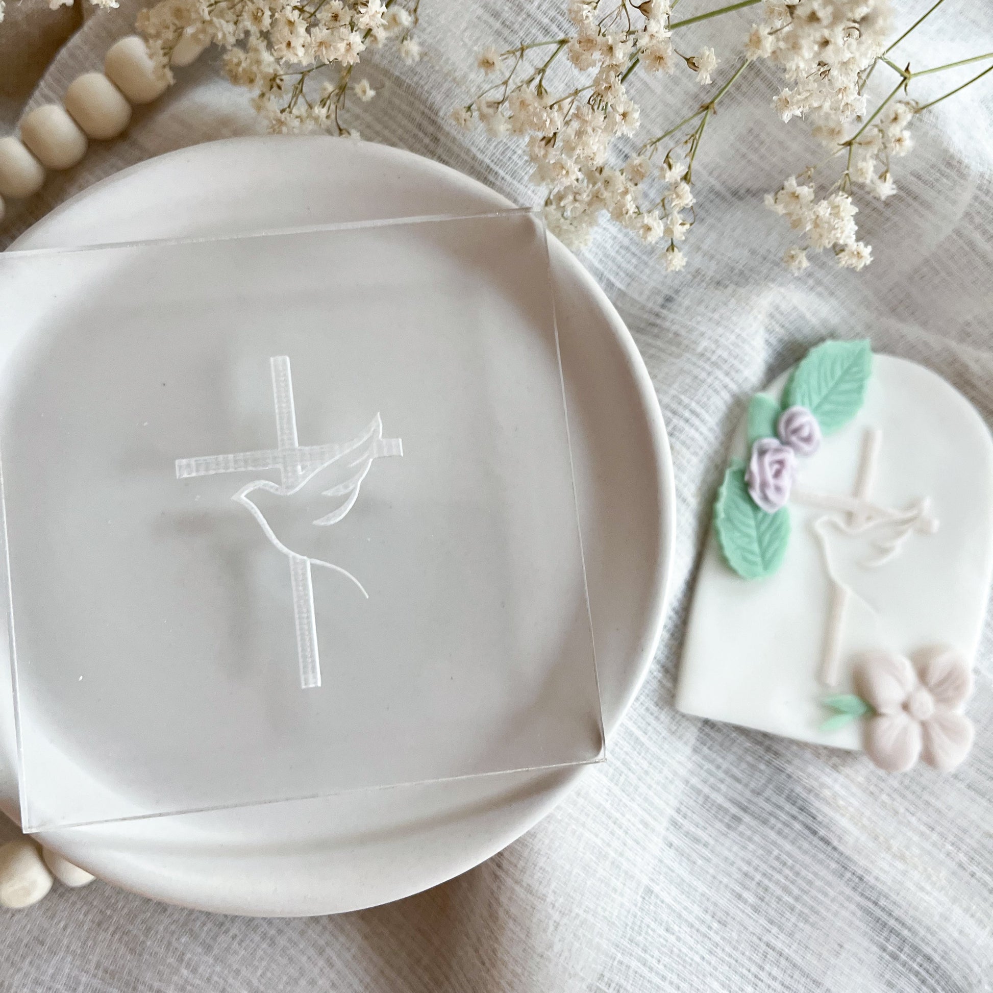 Vertical cookie embosser with dove and cross design for spiritual events and religious cookies.