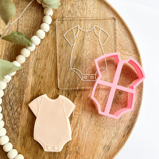 Baby onesie cookie cutter with matching embosser for baby shower cookie decorating and newborn celebration baking.