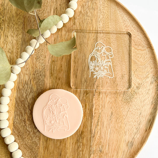 Cookie embosser featuring a bride and groom embracing, perfect for romantic wedding cookies and bridal-themed fondant designs.