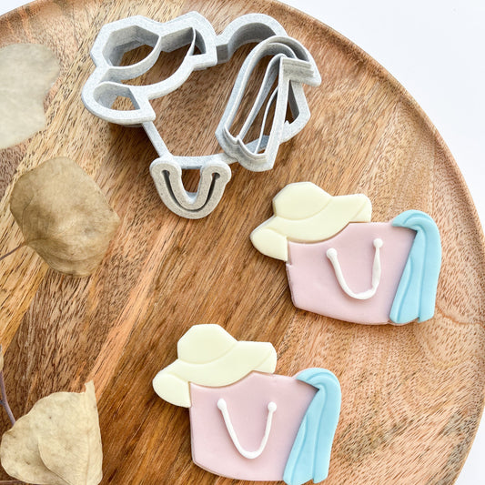 Cookie cutters shaped like handbags on a wooden board