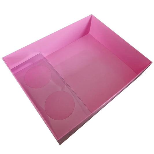 Pink plastic tray with circular cutouts on a white background