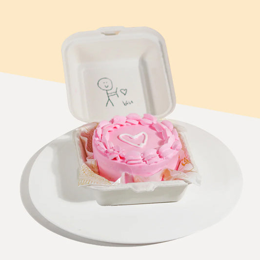 Pink flower in a white box with a heart design on a light beige background