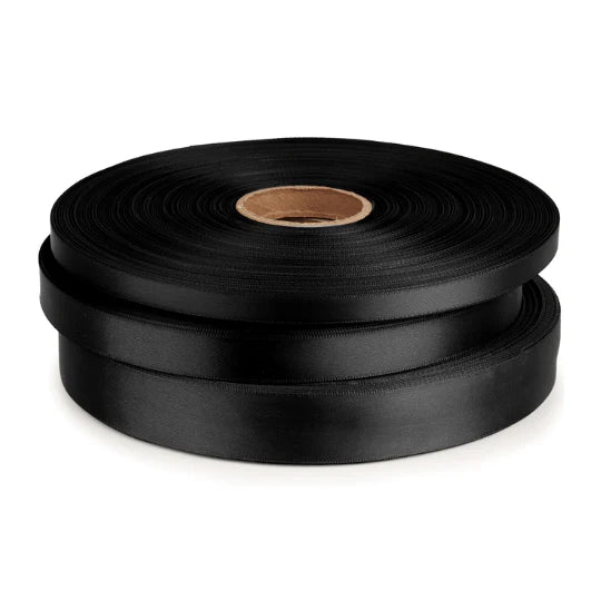 Two rolls of black ribbon on a white background