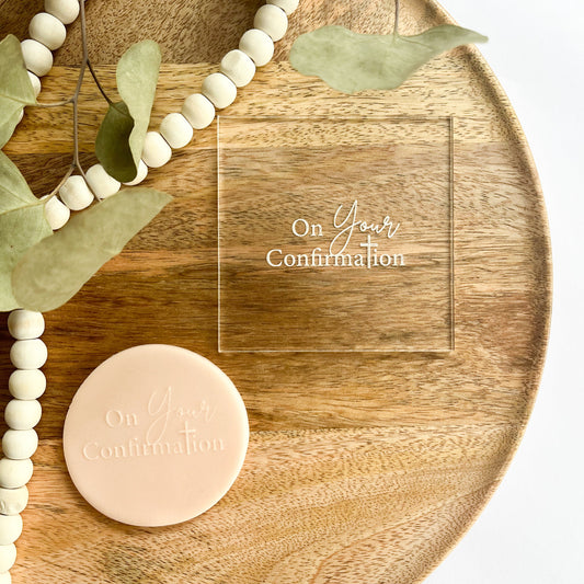 Clear acrylic cookie embosser with elegant "On Your Confirmation" script design, perfect for decorating confirmation cookies and gifts for religious celebration.