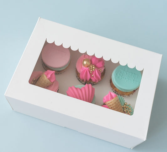 Decorative box with colorful cookies on a light blue background