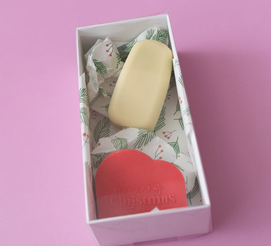 Bar of soap in a decorative box with a pink background