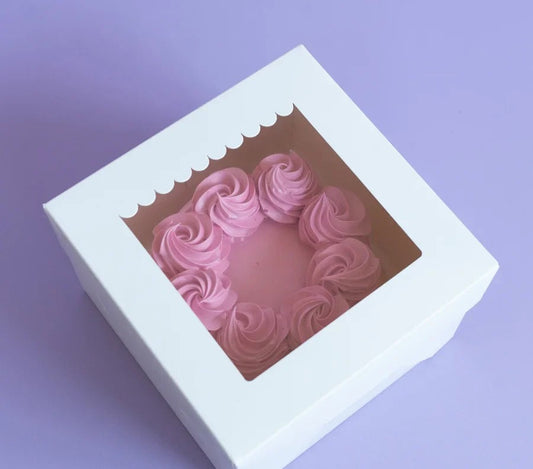 Pink heart-shaped soap in a white box on a purple background